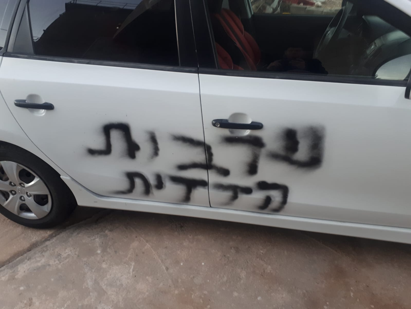 مستوطنون يحرقون سيارة ويكتبون شعارات عنصرية قرب نابلس